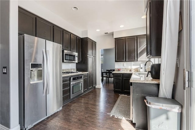 45077 Corte Bravo, Temecula, CA 92592 - kitchen featuring stainless steel appliances, dark wood-type flooring, dark brown cabinetry, a sink, and recessed lighting