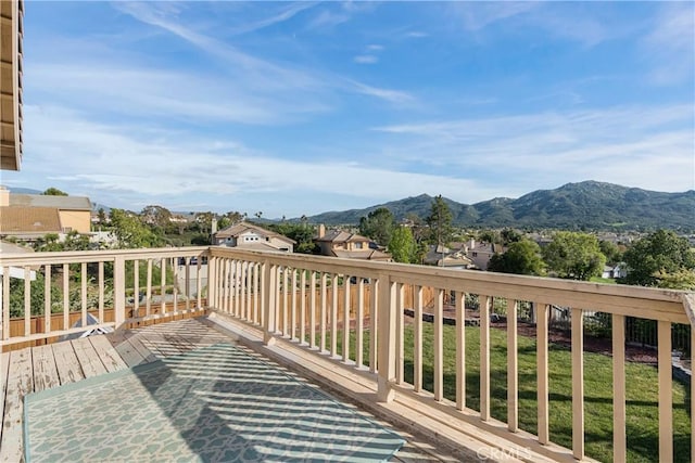 wooden terrace featuring a mountain view and a residential view