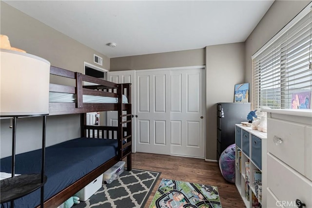 bedroom featuring dark wood-style floors and visible vents