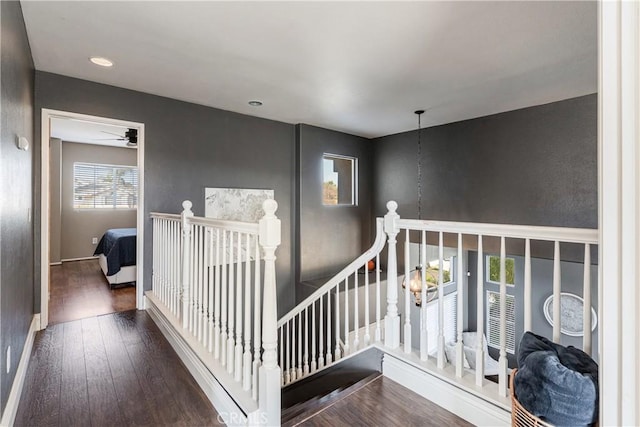 staircase with baseboards, recessed lighting, ceiling fan, and wood finished floors