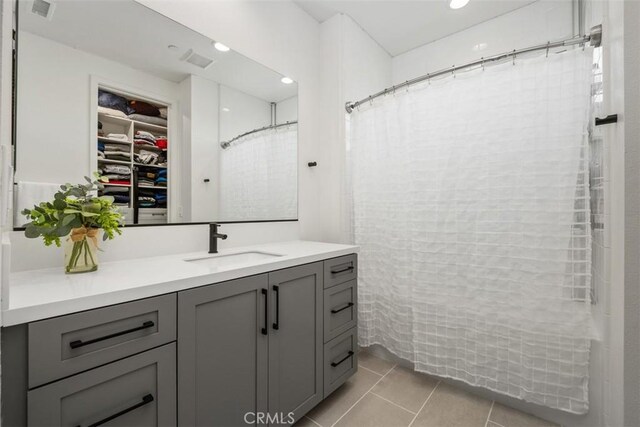 297 Sawbuck, Irvine, CA 92618 - bathroom with vanity, tile patterned floors, a spacious closet, curtained shower, and recessed lighting