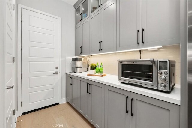 297 Sawbuck, Irvine, CA 92618 - kitchen featuring gray cabinetry, light wood finished floors, and light countertops