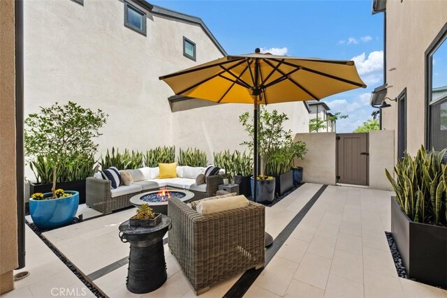 297 Sawbuck, Irvine, CA 92618 - view of patio featuring a gate and an outdoor living space with a fire pit