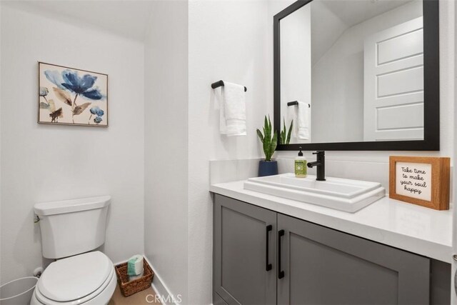 297 Sawbuck, Irvine, CA 92618 - half bathroom with vanity, baseboards, and toilet