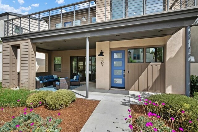 297 Sawbuck, Irvine, CA 92618 - doorway to property with an outdoor hangout area, a balcony, stucco siding, and a patio area