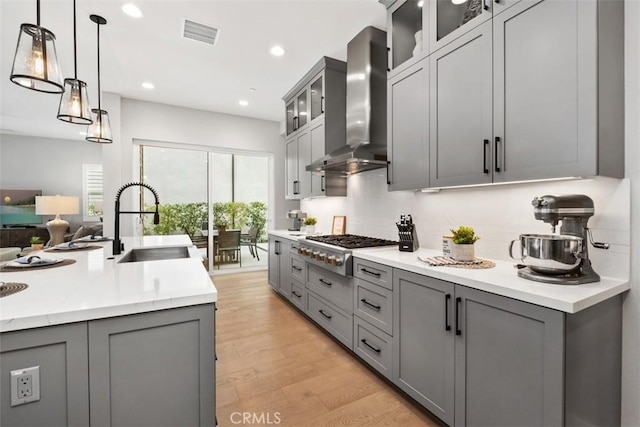 297 Sawbuck, Irvine, CA 92618 - kitchen featuring wall chimney range hood, gray cabinets, a sink, and recessed lighting