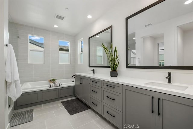 297 Sawbuck, Irvine, CA 92618 - bathroom with a tub, double vanity, tile patterned flooring, a shower, and recessed lighting