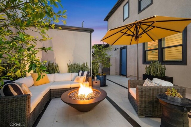 297 Sawbuck, Irvine, CA 92618 - patio terrace at dusk featuring an outdoor living space with a fire pit and a patio