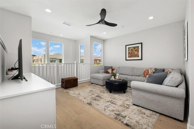 297 Sawbuck, Irvine, CA 92618 - living area with light wood finished floors, plenty of natural light, ceiling fan, and recessed lighting