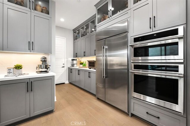 297 Sawbuck, Irvine, CA 92618 - kitchen with appliances with stainless steel finishes, gray cabinetry, light wood finished floors, light countertops, and recessed lighting