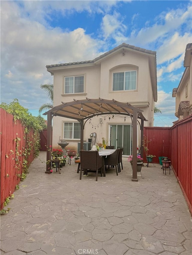 7163 Watcher St, Commerce, CA 90040 - back of property with a pergola, stucco siding, a patio, and a fenced backyard