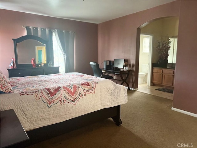 7163 Watcher St, Commerce, CA 90040 - bedroom featuring arched walkways, carpet floors, and connected bathroom