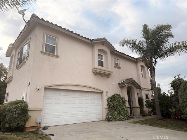 7163 Watcher St, Commerce, CA 90040 - mediterranean / spanish house featuring stucco siding, concrete driveway, and a tile roof