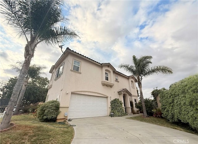 7163 Watcher St, Commerce, CA 90040 - mediterranean / spanish-style house with an attached garage, stucco siding, driveway, and a tile roof