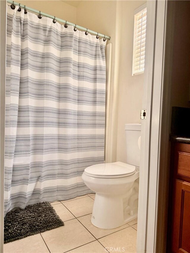 7163 Watcher St, Commerce, CA 90040 - bathroom with tile patterned flooring, toilet, and a shower with shower curtain