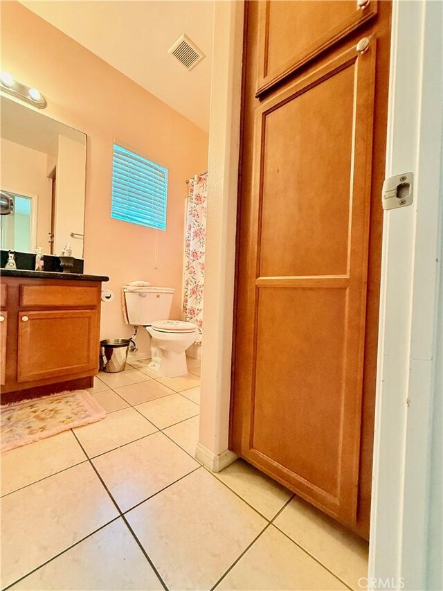 7163 Watcher St, Commerce, CA 90040 - full bathroom with tile patterned flooring, toilet, vanity, and a shower with shower curtain
