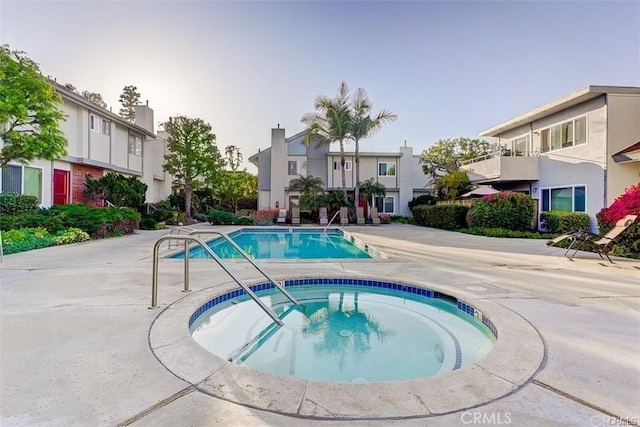 view of pool with a residential view and a community hot tub