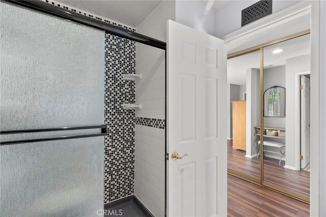 27736 Cherry Creek Dr, Valencia, CA 91354 - bathroom featuring visible vents, wood finished floors, and a stall shower