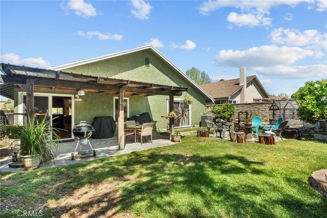 27736 Cherry Creek Dr, Valencia, CA 91354 - rear view of property featuring a lawn, a patio, and stucco siding