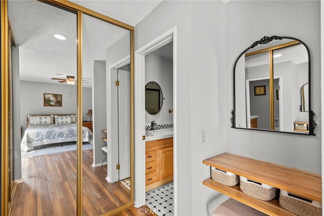 27736 Cherry Creek Dr, Valencia, CA 91354 - hall with recessed lighting, a textured ceiling, a sink, and wood finished floors