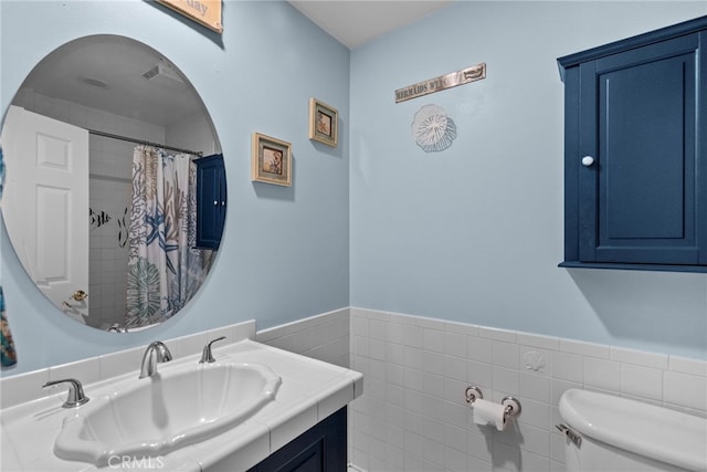 27736 Cherry Creek Dr, Valencia, CA 91354 - full bath featuring a wainscoted wall, vanity, toilet, and tile walls