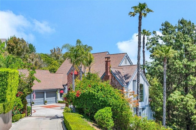 10302 Broadview Pl, North Tustin, CA 92705 - english style home featuring an attached garage, stucco siding, driveway, and a tile roof
