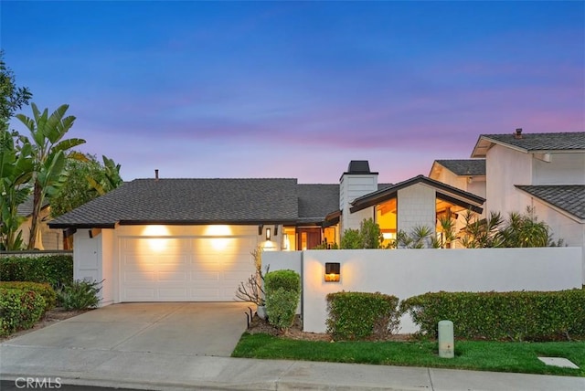 14 Woodsong Dr, Laguna Niguel, CA 92677 - view of front of home featuring an attached garage, driveway, and a chimney