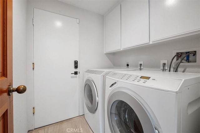 14 Woodsong Dr, Laguna Niguel, CA 92677 - washroom with washing machine and dryer, cabinet space, and light wood-type flooring