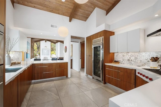 14 Woodsong Dr, Laguna Niguel, CA 92677 - kitchen with modern cabinets, wine cooler, wooden ceiling, decorative backsplash, and light countertops