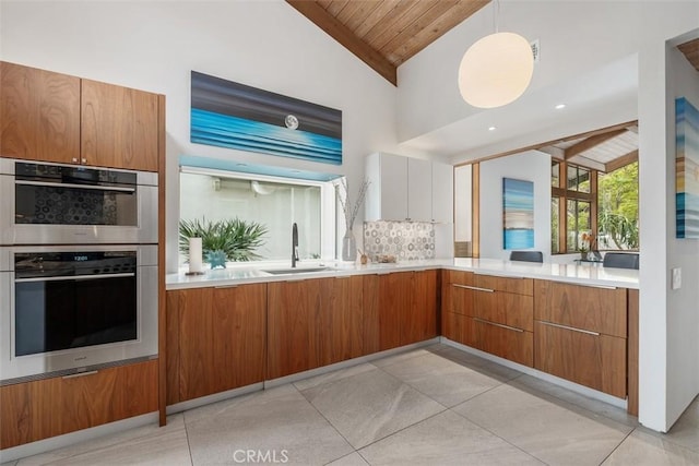 14 Woodsong Dr, Laguna Niguel, CA 92677 - kitchen featuring lofted ceiling, stainless steel double oven, a sink, brown cabinets, and wood ceiling