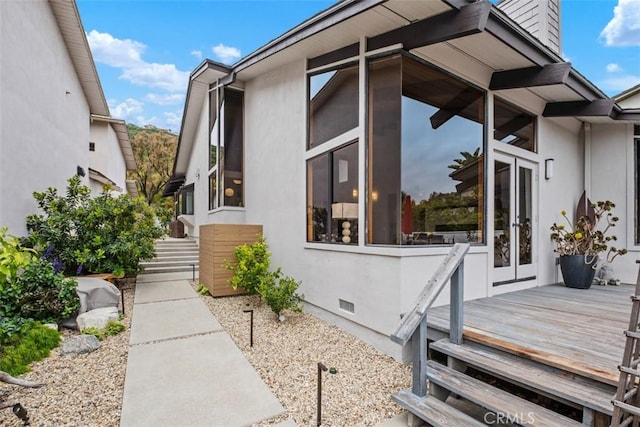 14 Woodsong Dr, Laguna Niguel, CA 92677 - view of side of property featuring a wooden deck, crawl space, stucco siding, and a chimney