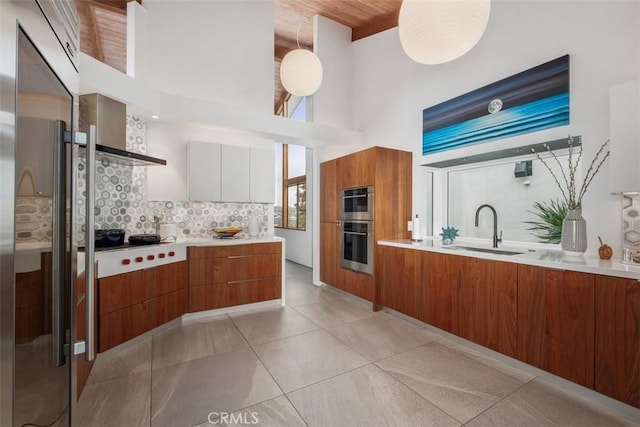 14 Woodsong Dr, Laguna Niguel, CA 92677 - kitchen with a sink, modern cabinets, brown cabinetry, and a towering ceiling