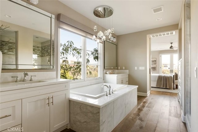 101 Via Artemesia, San Clemente, CA 92672 - ensuite bathroom with wood-type flooring, two vanities, a garden tub, and a ceiling fan