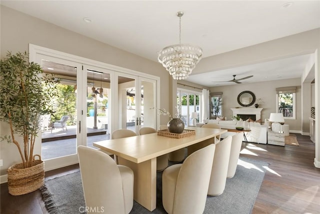 101 Via Artemesia, San Clemente, CA 92672 - dining area featuring french doors, ceiling fan, dark wood-style flooring, a chandelier, and a fireplace