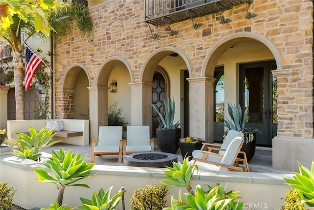 view of patio with a fire pit and french doors