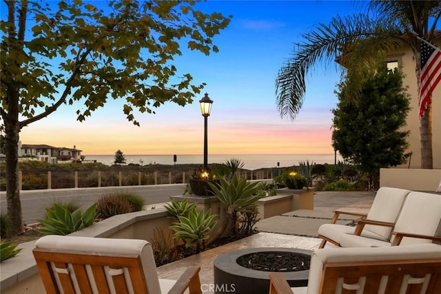 101 Via Artemesia, San Clemente, CA 92672 - patio terrace at dusk featuring a fire pit, a water view, and a patio