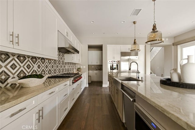 101 Via Artemesia, San Clemente, CA 92672 - kitchen featuring under cabinet range hood, appliances with stainless steel finishes, light stone countertops, white cabinetry, and recessed lighting