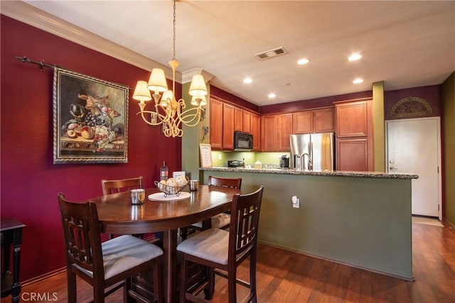 28365 Socorro St Unit 45, Murrieta, CA 92563 - dining area featuring a chandelier, dark wood finished floors, recessed lighting, and crown molding