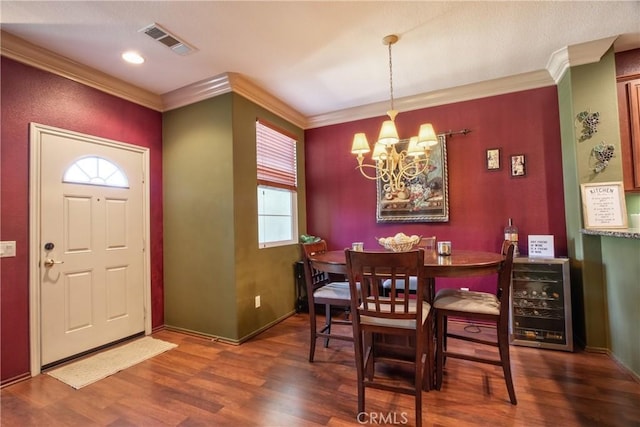 28365 Socorro St Unit 45, Murrieta, CA 92563 - dining space featuring ornamental molding, a chandelier, wine cooler, wood finished floors, and baseboards