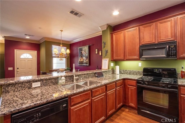 28365 Socorro St Unit 45, Murrieta, CA 92563 - kitchen with black appliances, a sink, stone countertops, a chandelier, and wood finished floors
