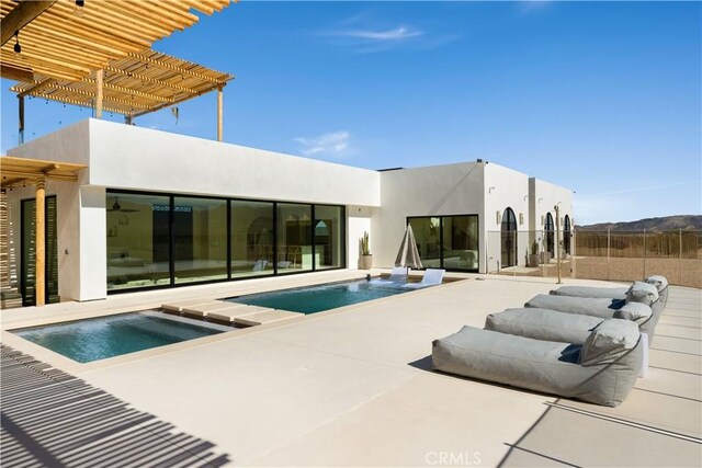 63973 Gold Nugget Rd, Joshua Tree, CA 92252 - rear view of house with a patio, an outdoor pool, stucco siding, and a pergola