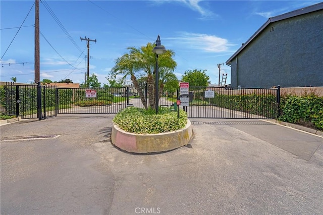 12812 Timber Rd Unit 22, Garden Grove, CA 92840 - view of asphalt street with a gate, a gated entry, and street lighting