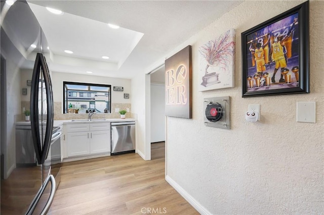 12812 Timber Rd Unit 22, Garden Grove, CA 92840 - bar area featuring appliances with stainless steel finishes, light wood-type flooring, a textured wall, a tray ceiling, and recessed lighting