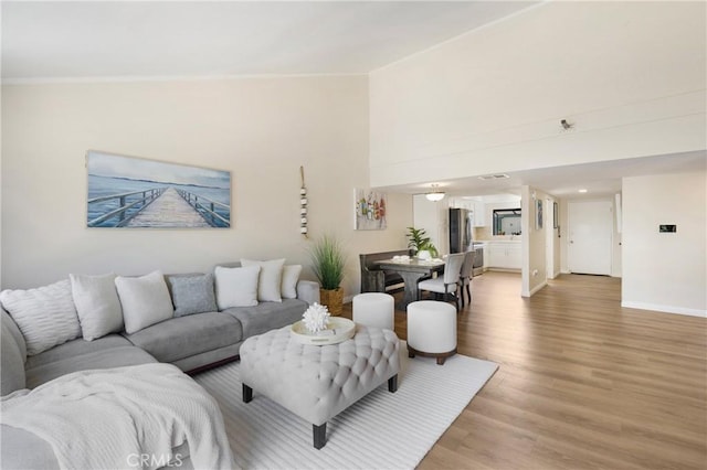 12812 Timber Rd Unit 22, Garden Grove, CA 92840 - living area featuring light wood-type flooring and ornamental molding