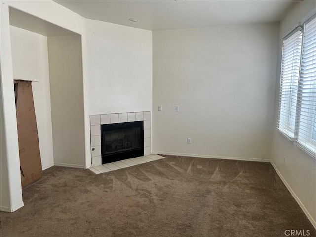 938 Sparrow Way, Perris, CA 92571 - unfurnished living room with baseboards, a tiled fireplace, and carpet