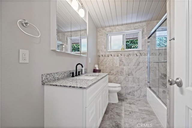 bathroom featuring vanity, wood ceiling, combined bath / shower with glass door, and toilet
