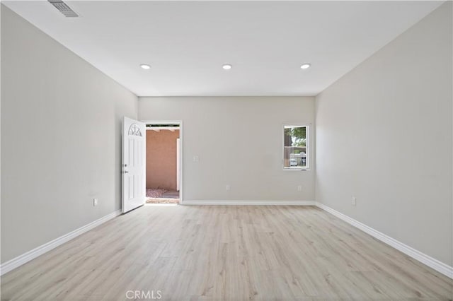 spare room featuring recessed lighting, baseboards, visible vents, and light wood-style floors