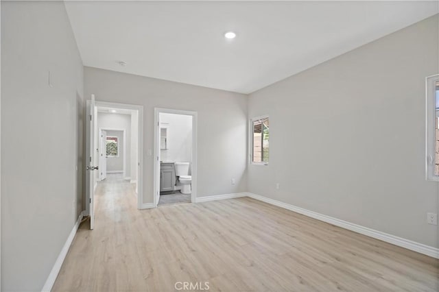 interior space featuring recessed lighting, baseboards, multiple windows, and light wood-type flooring