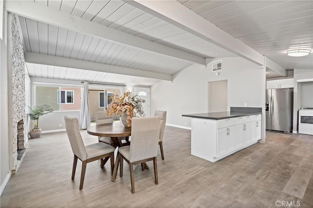 dining area featuring baseboards, light wood-style flooring, and visible vents