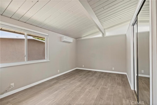 empty room with wood finished floors, baseboards, a wall mounted air conditioner, vaulted ceiling with beams, and wood ceiling